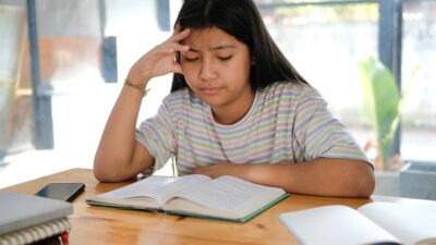 asian girl student studying hard feeling stressed tired exhausted bored. children education