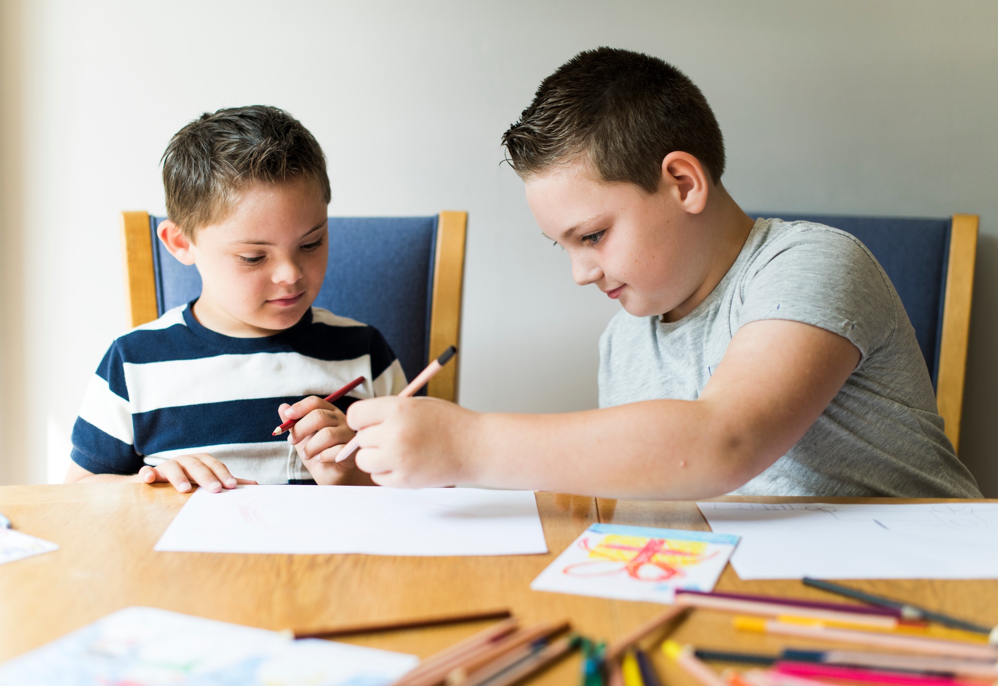 Cute brothers drawing at a table