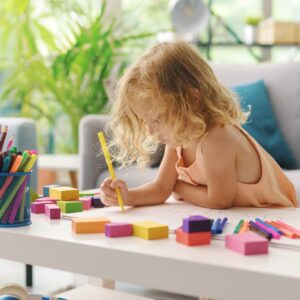 Cute girl coloring with markers