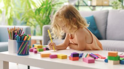 Cute girl coloring with markers
