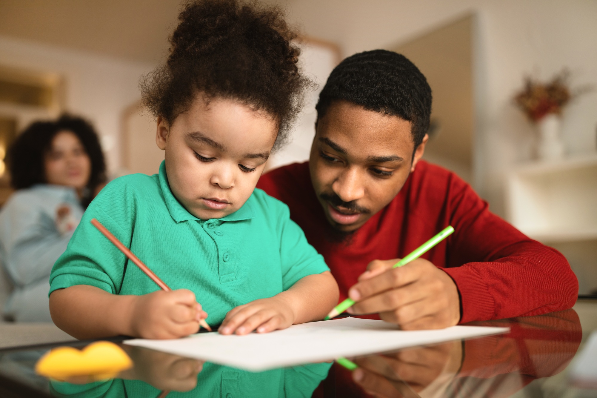 Cute little kid girl coloring with her loving father
