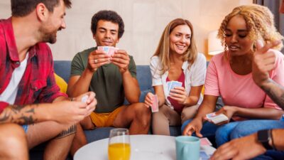 Friends having fun playing card games at home