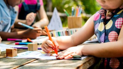 Group of kindergarten kids friends drawing art class outdoors