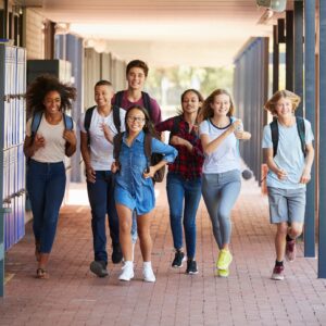 Teenager school kids running in high school hallway